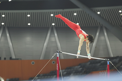 ◎ 十一月十七日晚,第十五屆全國運動會體操項目男子單杠決賽在廣東肇慶舉行,湖南隊張博恒奪冠。圖為張博恒在比賽中。(中新社記者 陳楚紅 攝)