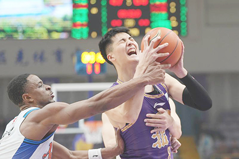 ◎ 十二月十八日,北京控股隊球員朱松瑋(右)突破受阻。CBA常規賽第三輪比賽中,北京控股隊主場九十五比一百零五不敵新疆伊力特隊。(新華社記者謝晗 攝)