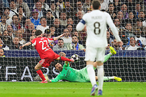 ◎ 二月二十五日,在西班牙馬德里。賓菲加隊球員拉法·施華(左)在皇家馬德里隊與賓菲加隊之間的歐洲冠軍聯賽附加賽第二回合比賽中攻入首球。(美聯社/馬努費爾南德斯)